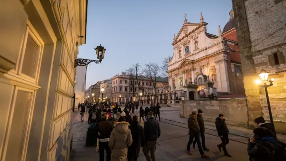 Kraków, Poland: People walk along the streets at night in the Kraków Old City. Photo: LWF/Albin Hillert